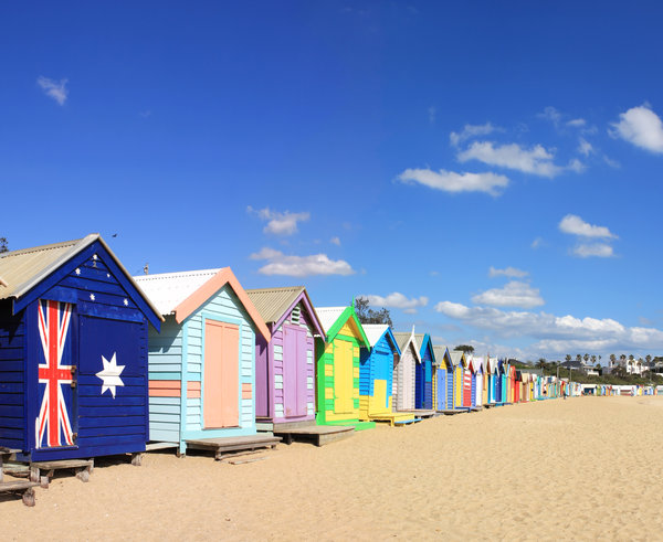 Colorful bathing boxes lined up on Brighton Beach in Melbourne, their vibrant hues adding charm to the seaside experience, often seen from above on Melbourne helicopter tours.
