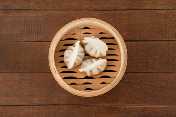 Three dumplings in bamboo steamer