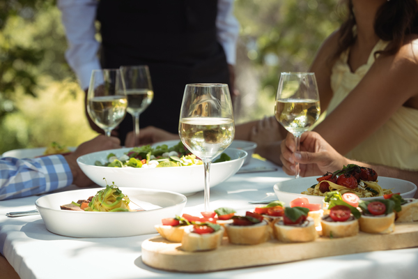 Close up of food and wine glass on dining table