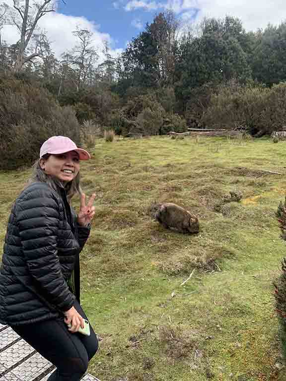 Author taking a selfie with a wombat on the Enchanted Walk, an activity near luxury accommodations in Cradle Mountain.