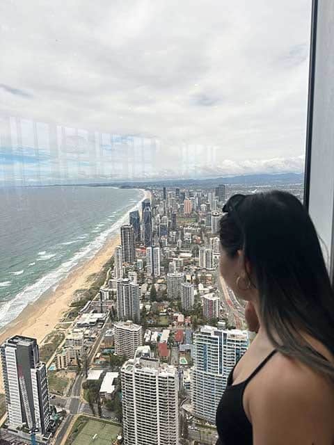 Kate gazes out from the SkyPoint Observation Deck at the expansive coastal and urban views, a must-visit on any Gold Coast itinerary.