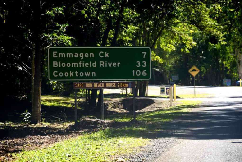 Road sign at Daintree National Park pointing towards Emmagen Creek, Bloomfield River, and Cooktown, essential stops for a scenic winter drive when exploring things to do around Cairns.