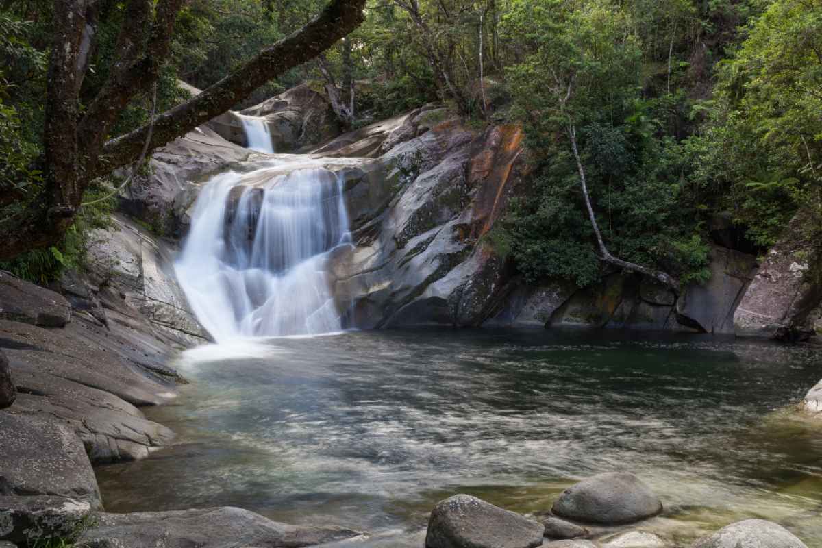 Josephine Falls in Queensland, Australia, a serene natural cascade surrounded by lush greenery, a perfect spot for a refreshing swim or picnic during Cairns in winter.