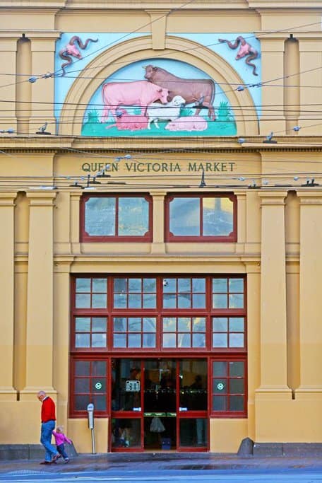 The entrance to Queen Victoria Market in Melbourne, featuring its iconic facade with animal artwork. During the holiday season, this market becomes a hub for Melbourne Christmas markets and activities, offering a festive shopping experience.
