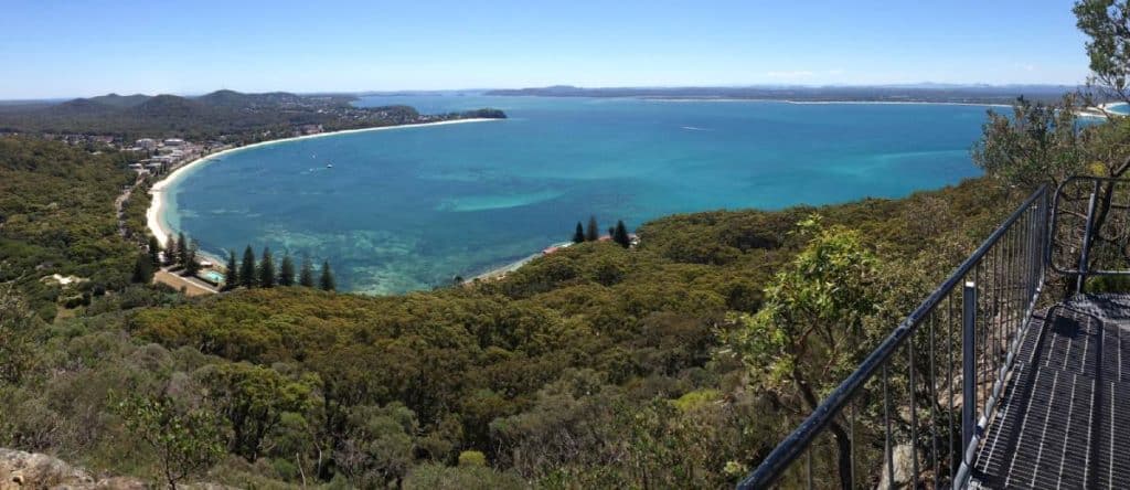 Sweeping panoramic view over Shoal Bay and the surrounding coastline from the summit of Mount Tomaree, a breathtaking lookout on the Sydney to Byron Bay driving route.