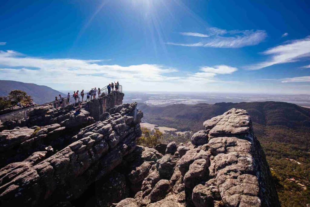 Crowds take in the iconic views from Pinnacle Lookout over Halls Gap and surrounds on the Wonderland hike loop in Victoria, Australia

