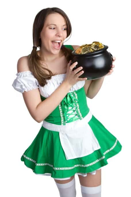 Woman dressed in a green Irish-inspired costume holding a pot of gold coins, representing the fun, festive outfits and lucky symbols seen during St. Patrick’s Day in Sydney celebrations.