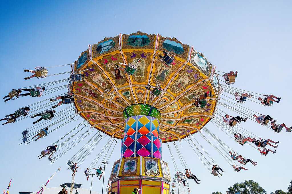 Colourful swing ride spinning high in the sky with people enjoying carnival thrills at the Sydney Royal Easter Show, showcasing the exciting amusement rides that draw crowds each year.