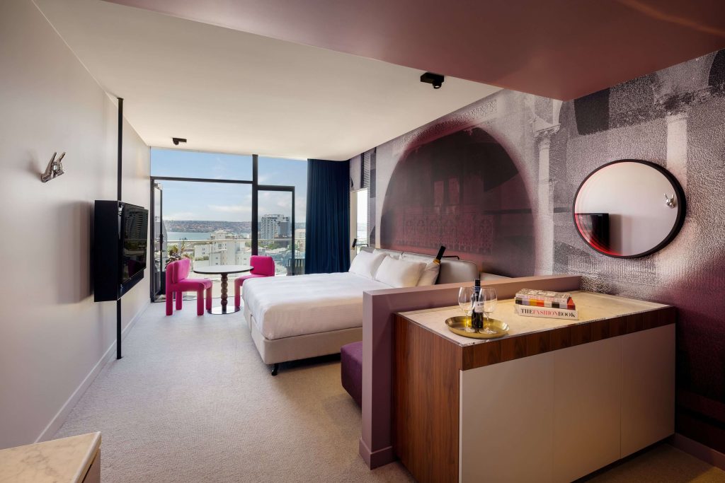 Stylish modern hotel room with balcony and Sydney Harbour views at Hotel Indigo in Potts Point Sydney, highlighting boutique stays in one of the best neighbourhoods in Sydney close to the city centre