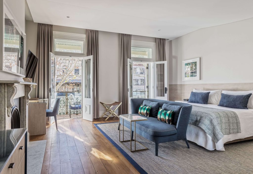 Elegant boutique hotel room with balcony doors and lounge area at Spicers Potts Point Sydney, highlighting luxury hotels in Sydney within one of the best neighbourhoods in Sydney near the harbour and city centre