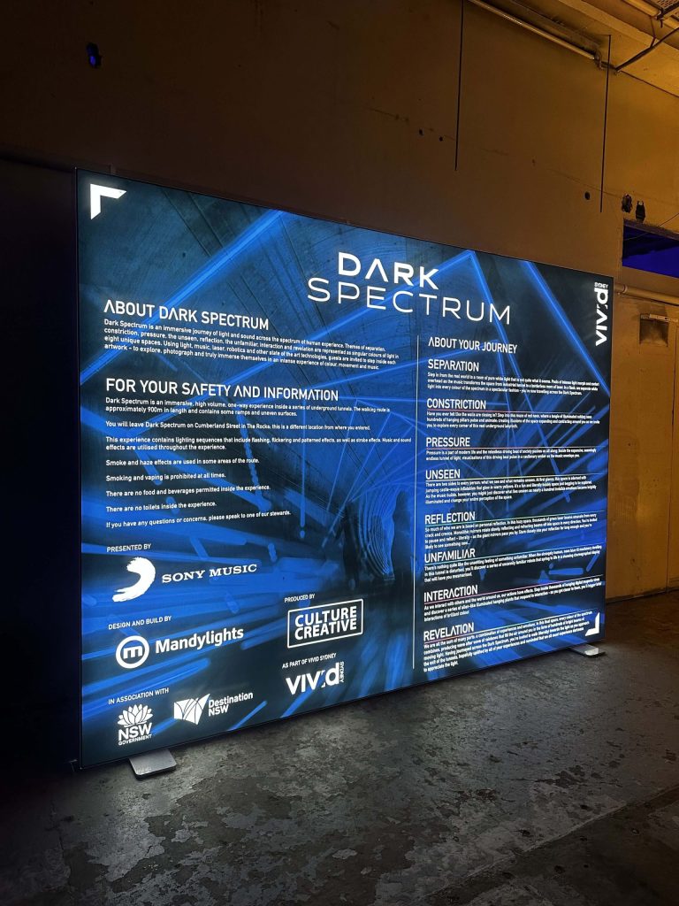 Dark Spectrum information board at Wynyard Tunnels explaining the immersive light installation experience, part of the interactive attractions at Vivid Sydney