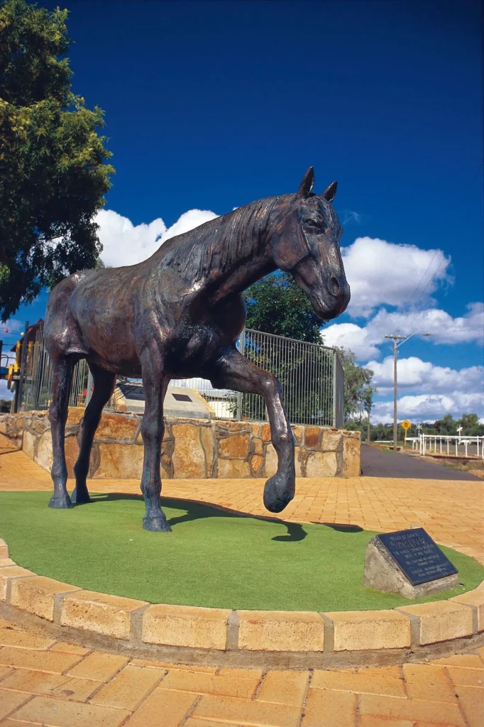 Bronze statue of Norseman the horse standing beneath a vivid blue sky in Norseman Western Australia. The landmark is a distinctive stop along the Brisbane to Perth road trip itinerary.