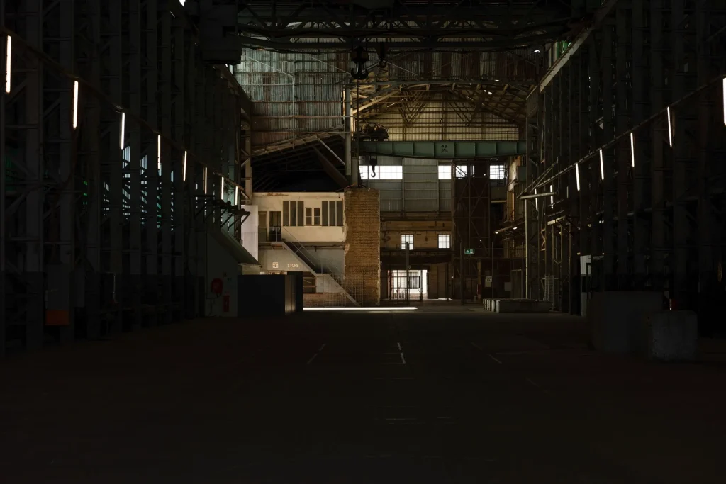 The dark, empty Turbine Hall on Cockatoo Island with old cranes and dim lights, a spooky stop on one of the best Sydney ghost tours