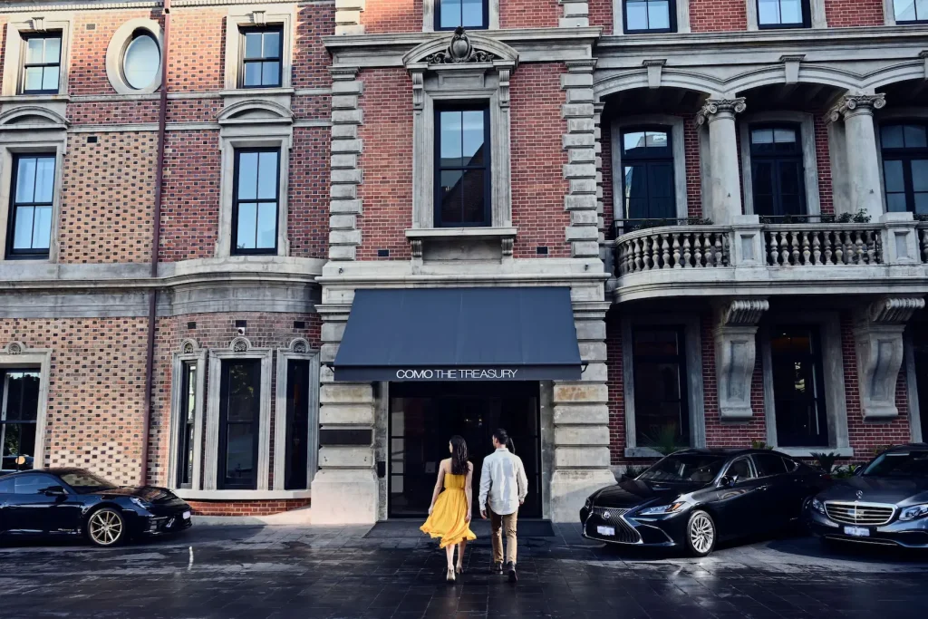 Luxury cars parked outside the historic COMO The Treasury building, a top pick for Perth accommodation with a pool