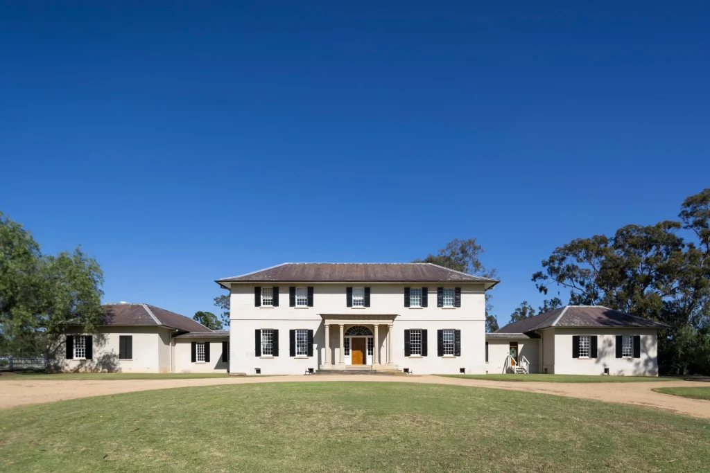 Old Government House in Parramatta Park with black shutters and a columned entrance, one of the most famous haunted places in Sydney