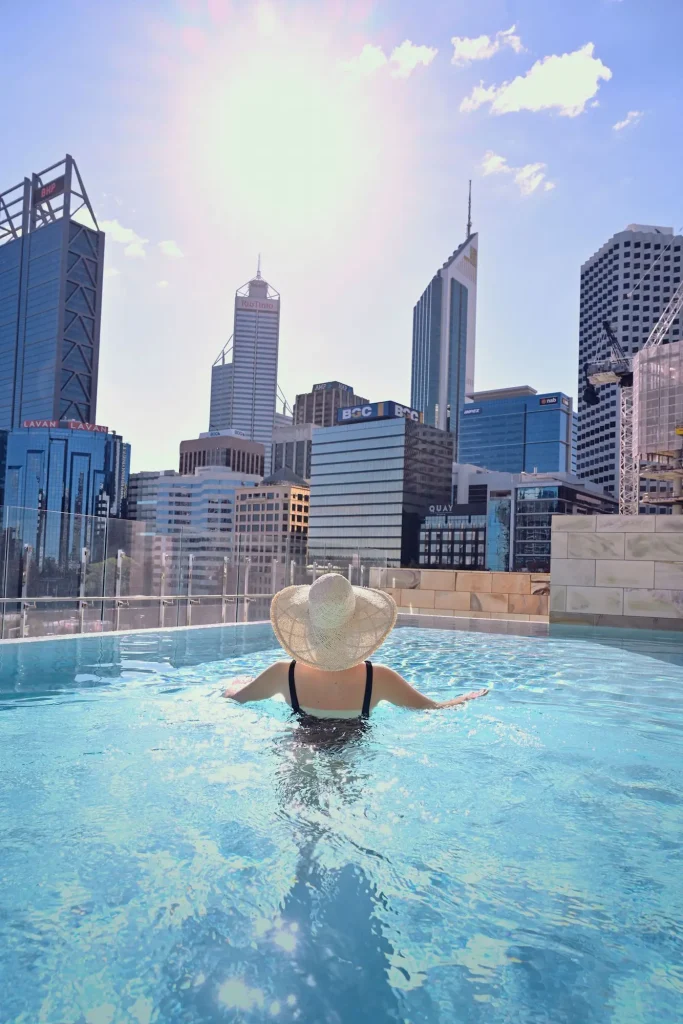 Sparkling blue water and Perth CBD skyline views from the pool at The Ritz-Carlton, Perth, a luxury pick for hotels in Perth with an infinity pool